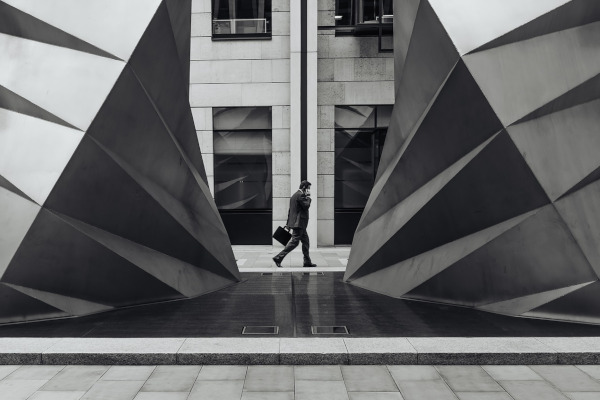 Businessman in front of a building, illustrating expert translation services in finance and business fields.