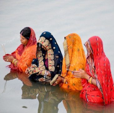 Four ladies praying in water, representing our commitment to professionalism and cultural understanding in our professional translation services.